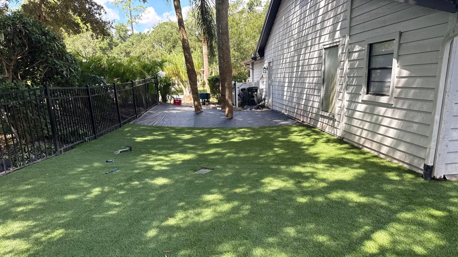 Freshly installed artificial grass along the side of a Tampa-area home